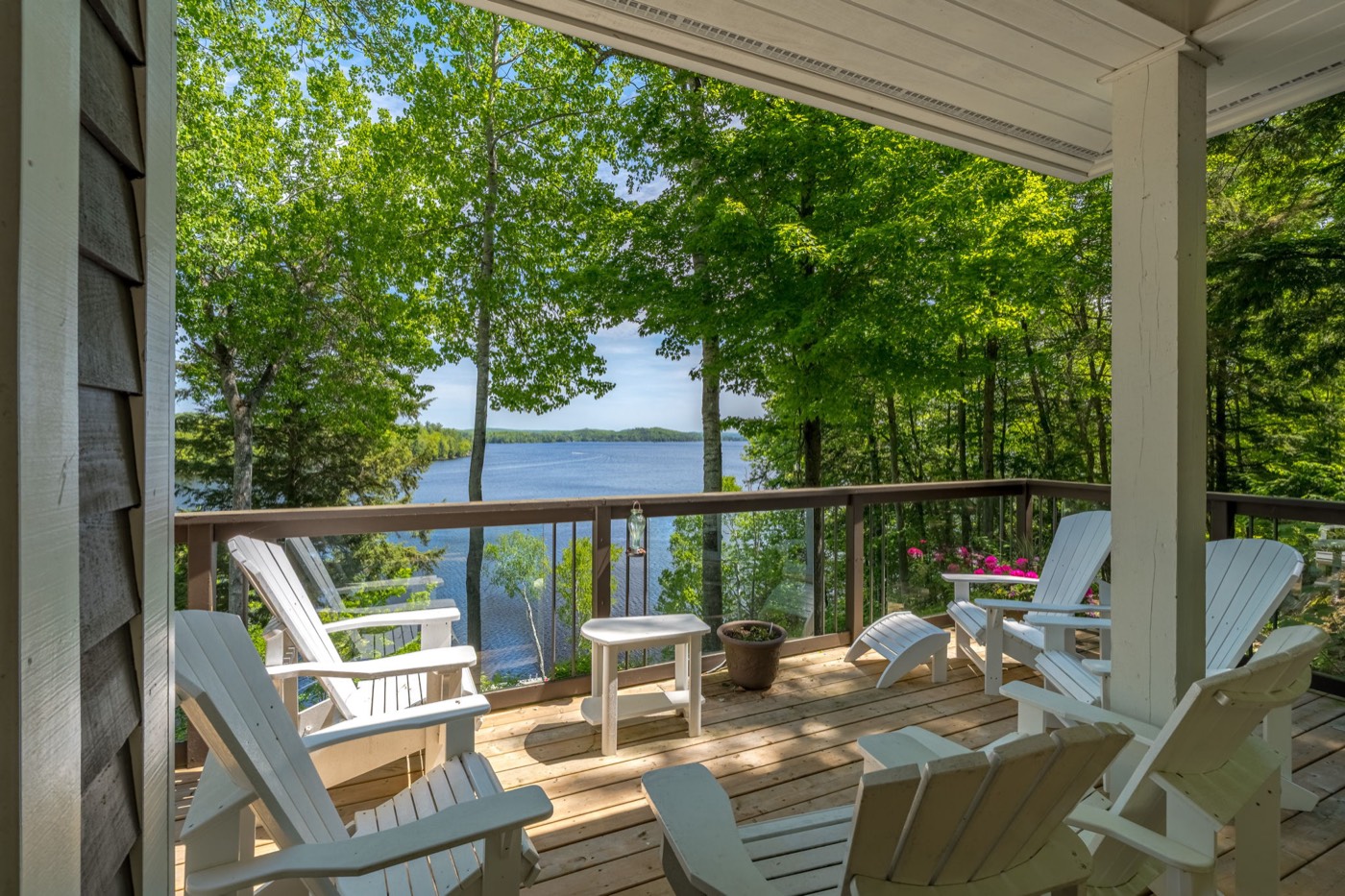 Covered porch with Muskoka chairs overlooking Fairy Lake